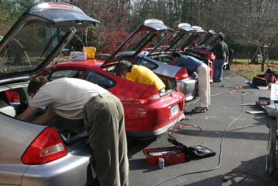 Who are these people and what are they doing to their cars?